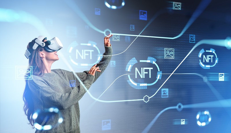 Young woman touch virtual hologram with non-fungible token hud | Can I Create My Own Cryptocurrency?