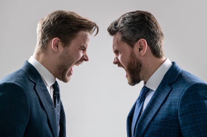 arguing businesspeople. dissatisfied men discuss failure | Is the Pandemic The Major Cause of Inflation? 