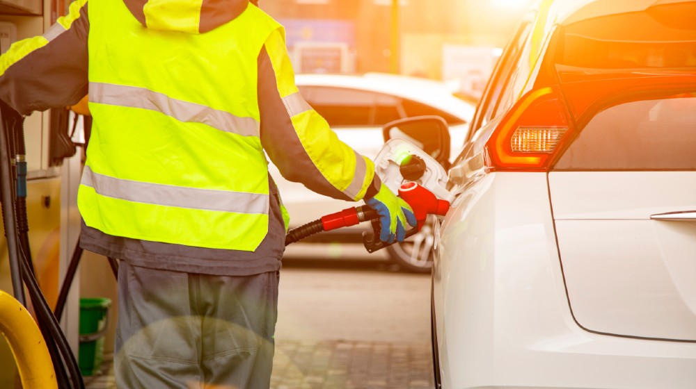 gas station employee in overalls refueling the car with petrol close up-$3 Per Gallon-ss-featured