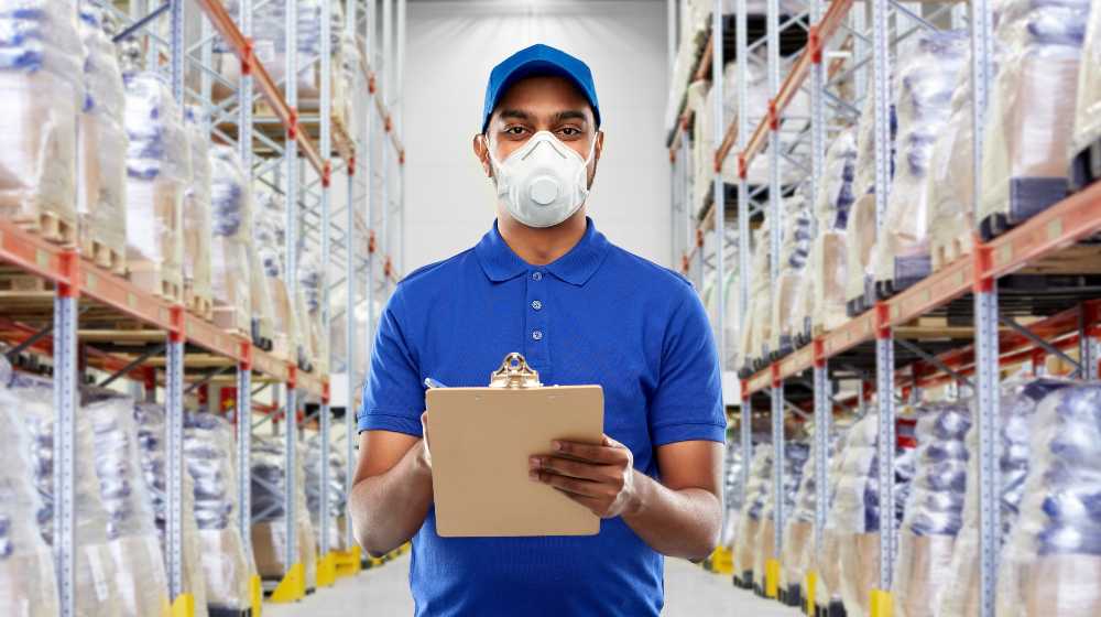 happy indian delivery man in blue uniform wearing face protective mask | There Are 3 Types of Pandemic Workers. Which One Are You? | featured
