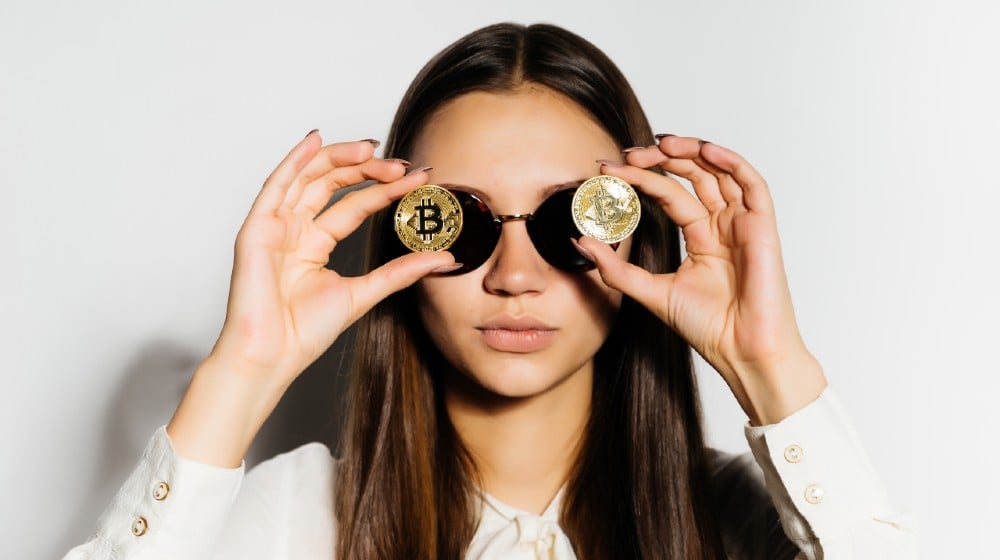 serious girl with black glasses put a coin to her eyes.bitcoins-Bitcoin Is Extremely Inefficient-ss-featured