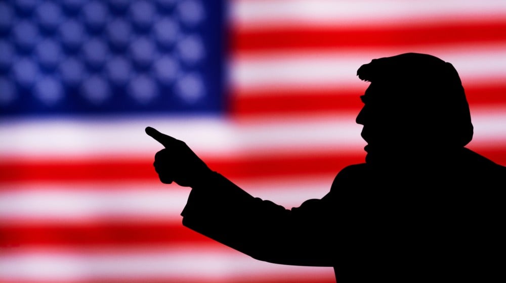 silhouette of Donald Trump against the background of the American flag | Trump Loses Appeal To Keep January 6 Documents Confidential | featured